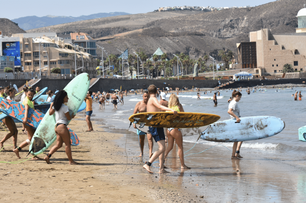 Instructor teaching someone how to surf near the shore