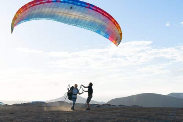 Two people getting ready for paragliding.