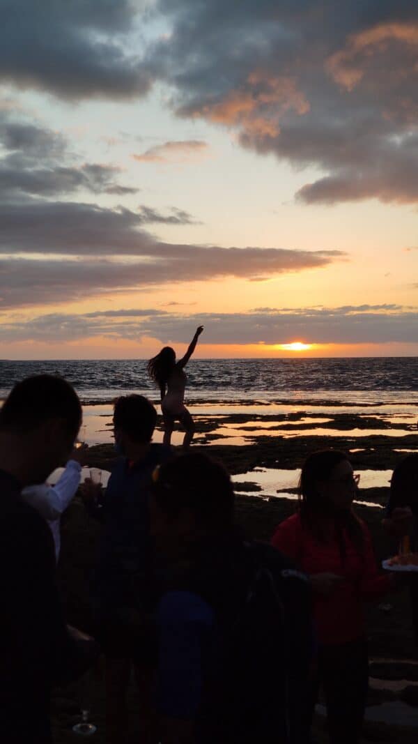 People on the beach at sunset.