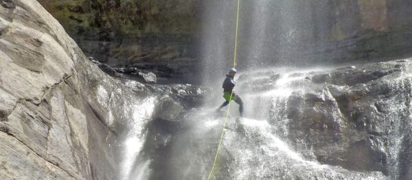 Person climbing to the top of a waterfall.