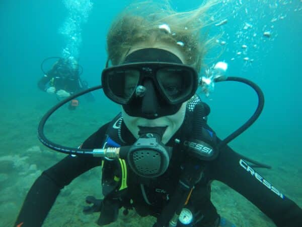 Person underwater with scuba diving equipment.