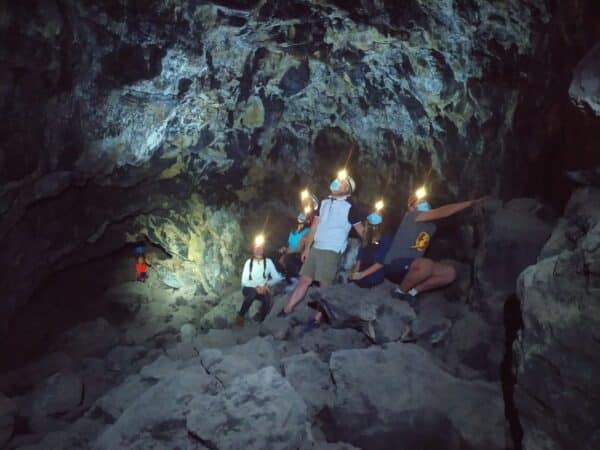 People in a cave with torches.
