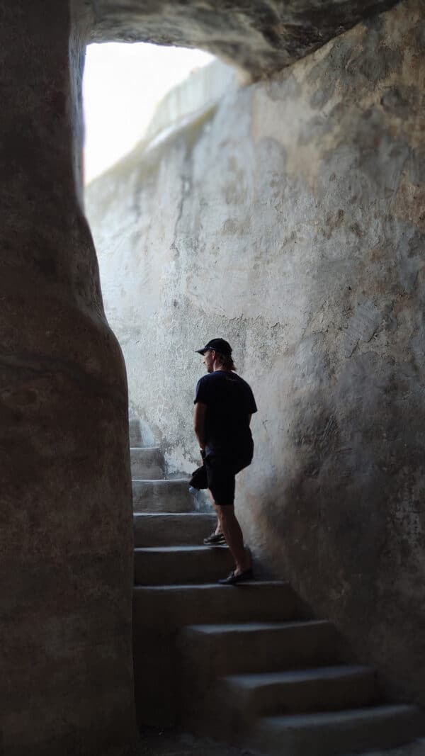 Person walking up the stairs in an abandoned place.