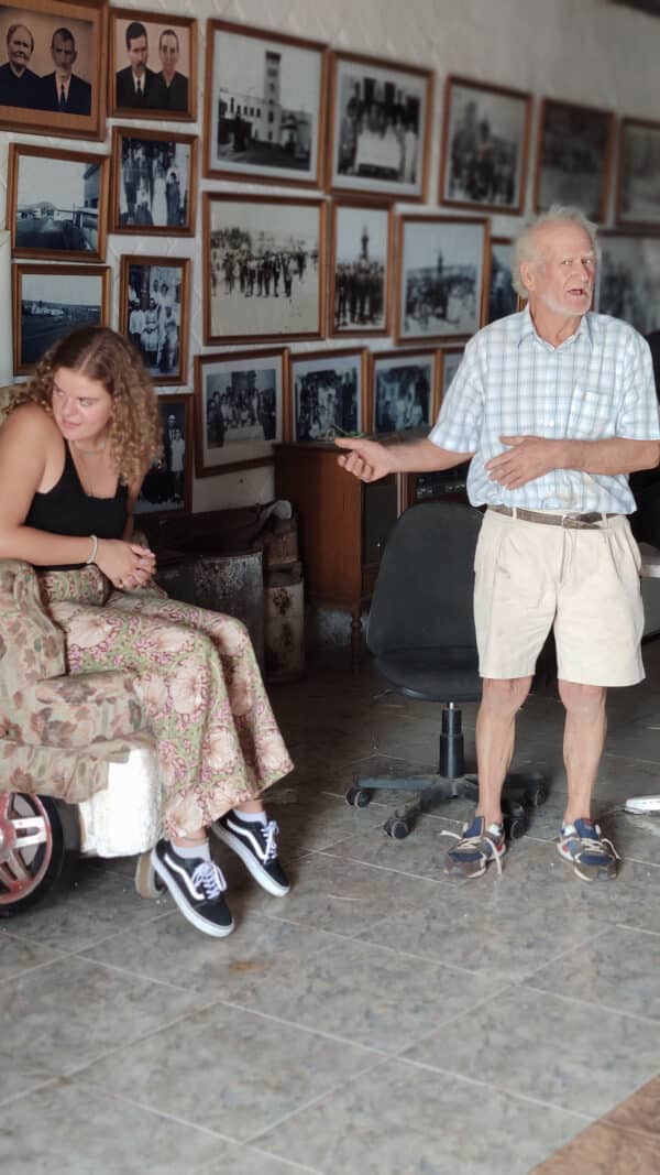 Old person talking with a woman sitting beside him.