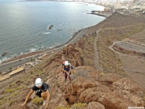Two people climbing.