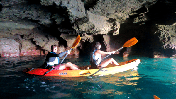 People kayaking in a cave.