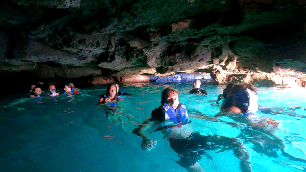 People swimming in a cave.