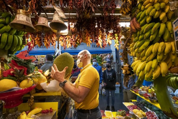 Someone carrying fruit in the market.