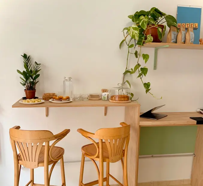 A coworking café in Gran Canaria, Spain, showcasing a cozy setup of tables and chairs for guests.